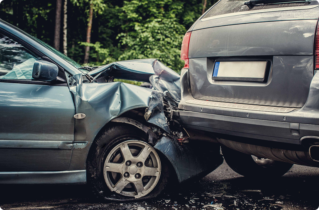 Front-end damage on a black car after a collision